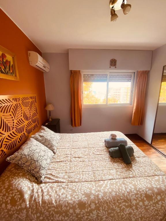 a bedroom with a bed with a teddy bear on it at TU CASA EN ESPAÑA Y PEATONAL - COCHERA PRIVADA INCLUIDA - Microcentro in Mendoza