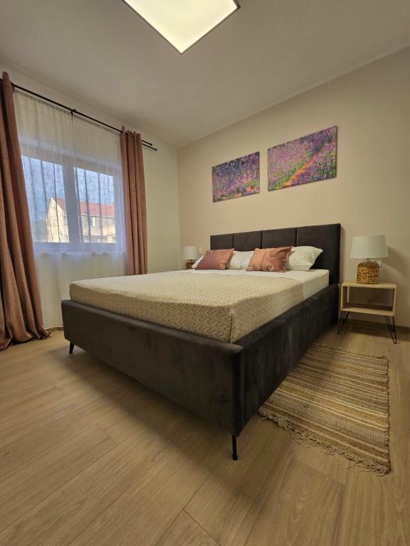 a bedroom with a large bed and a window at House Angelina in Kruševo