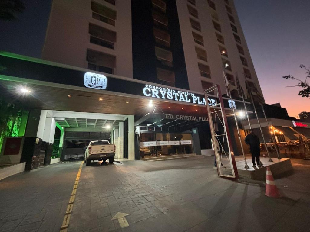 a man standing in front of a building at night at 1810 - Flat para temporada em Goiania-proximo ao Parque Areião in Goiânia