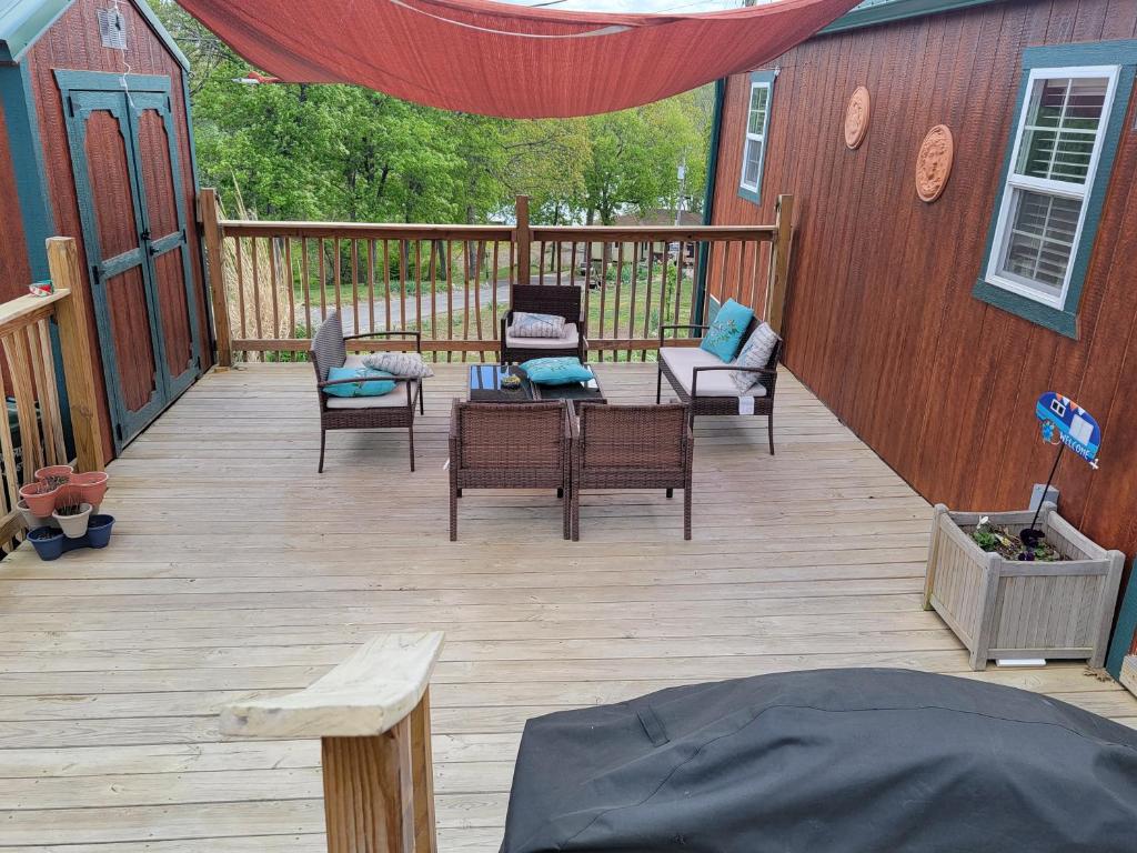 a deck with chairs and furniture on a house at 1 Fish in Warsaw