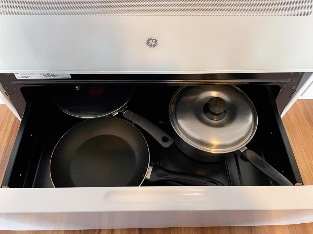 a stove with two pans inside of a box at Studio in Hilo Center with Pool and Lake Views in Hilo