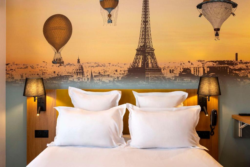 a bedroom with a bed with a poster of the eiffel tower at Hotel Apolonia Paris Mouffetard, Sure Hotel Collection by Best Western in Paris