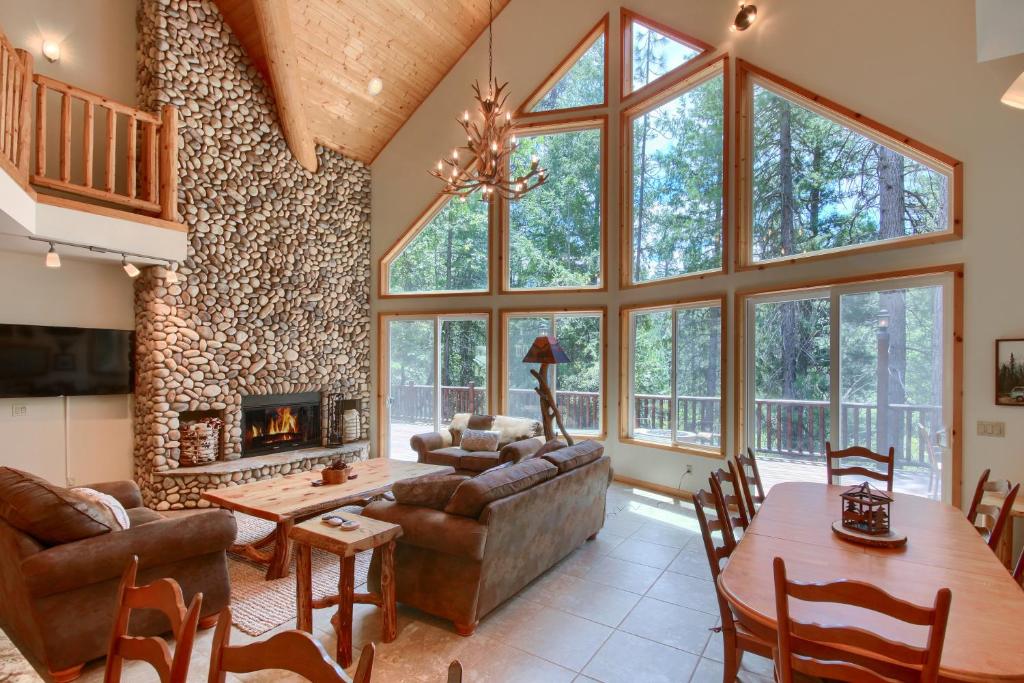 a living room with a couch and a fireplace at Rivercrest Lodge -Hot Tub -Pool Table -Firepit in Wawona