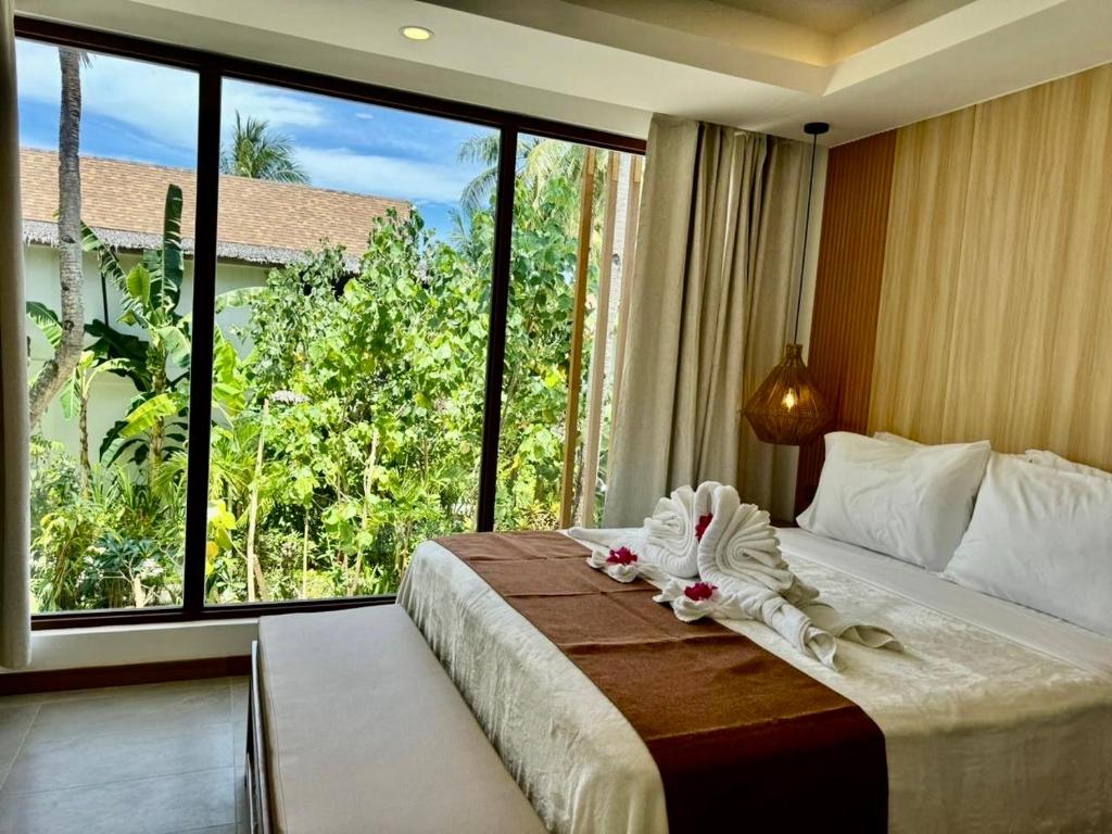 Postel nebo postele na pokoji v ubytování Siargao Island Villas