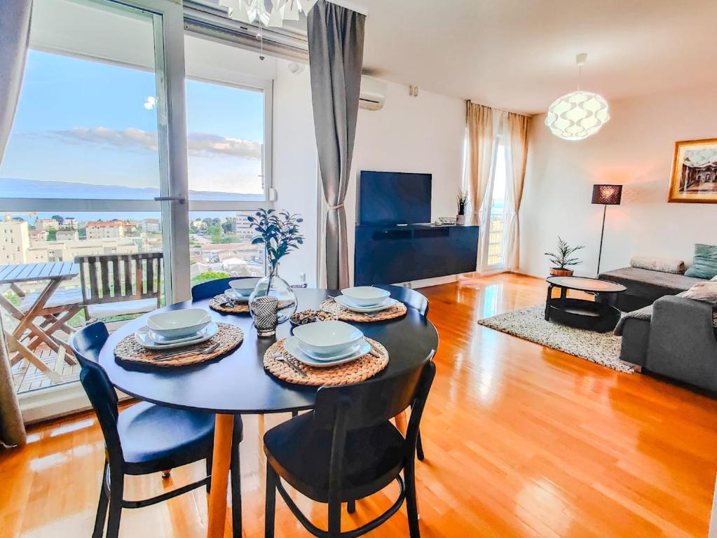 a dining room with a table and chairs in a living room at The Golden View Apartment in Split