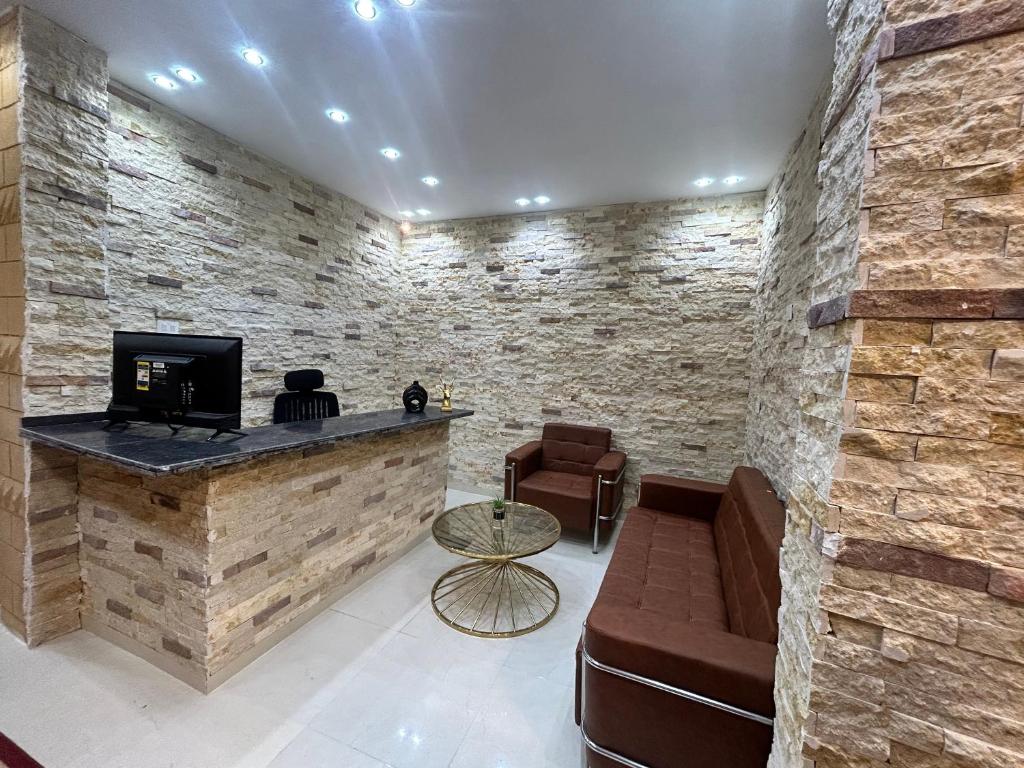 a lobby with a bar with a couch and a tv at Dima Pyramids View in Cairo