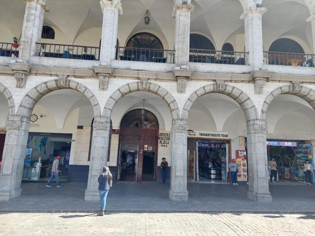 a woman standing in front of a building at Maison plaza in Arequipa