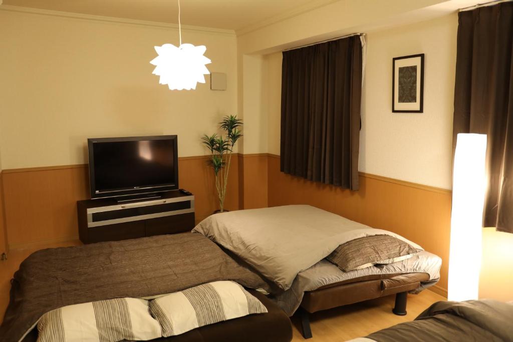 Postel nebo postele na pokoji v ubytování ケイアイコンホテルズ 新栄10階