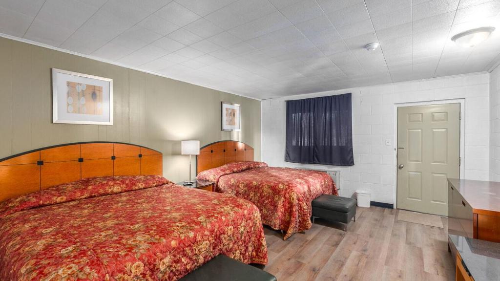 ein Hotelzimmer mit 2 Betten und roten Decken in der Unterkunft Stardust Motel Inn - West Side in El Dorado