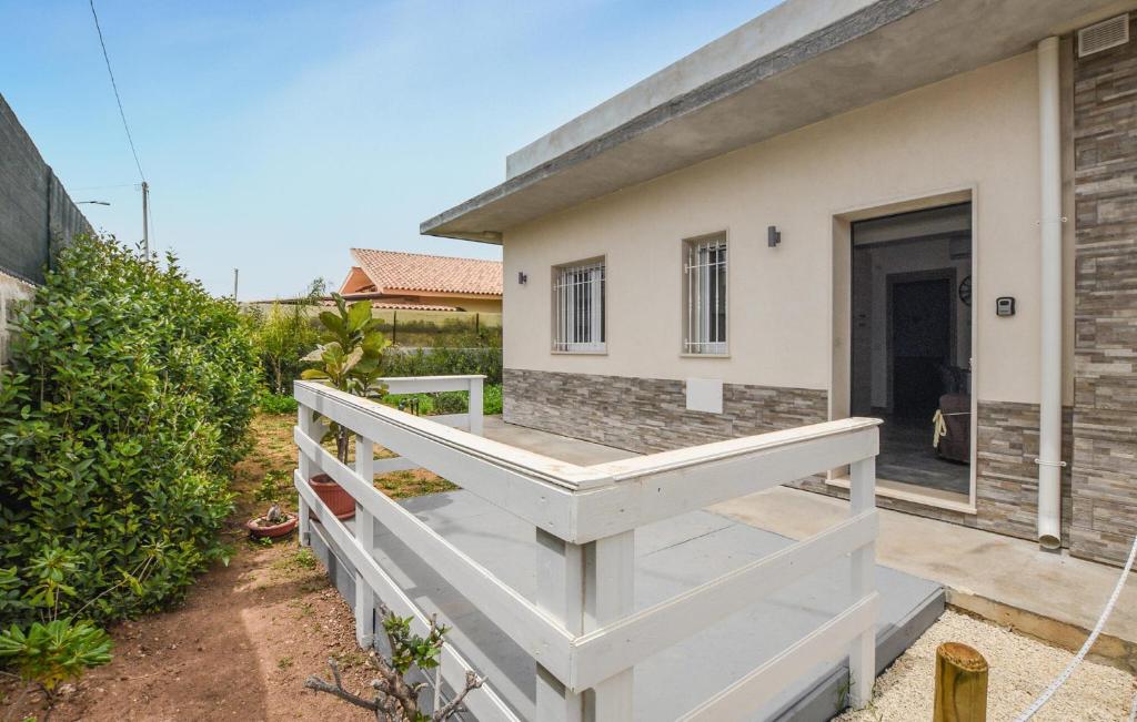 a house with a white staircase in front of a house at Stunning Home In Avola in Avola
