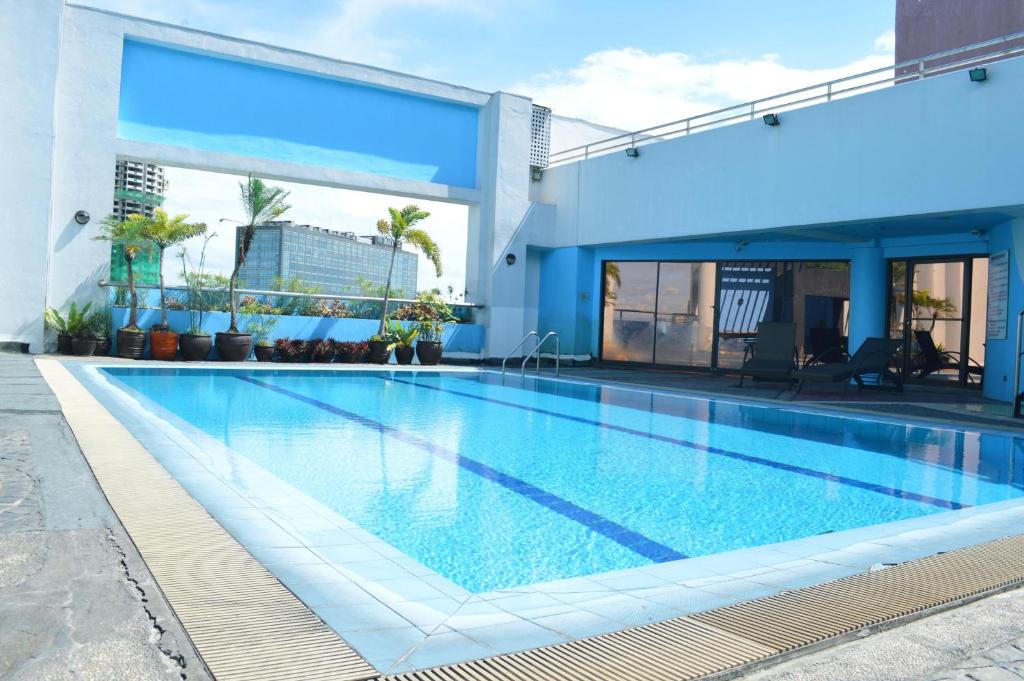 a large swimming pool in a building at Prince Plaza II Condotel in Manila