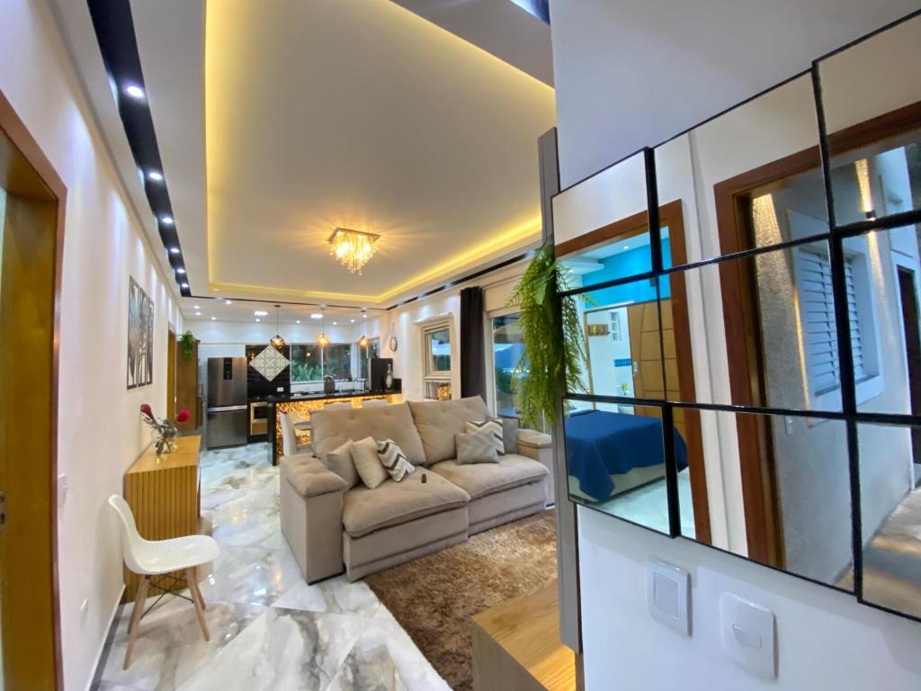 a living room with a couch and a table at Casa de praia com vista para o mar in São Sebastião