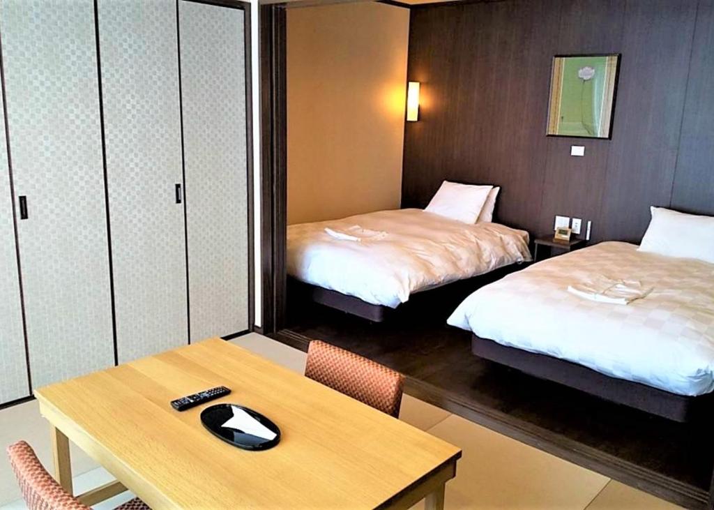 Postel nebo postele na pokoji v ubytování Hotel Morinokaze Hakone Sengokuhara