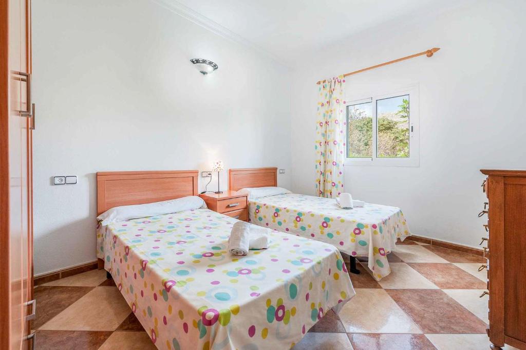 Postel nebo postele na pokoji v ubytování Villa Raquel