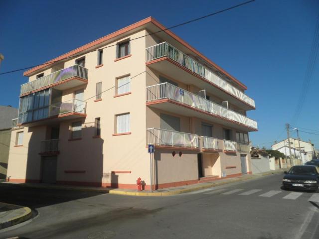 - un bâtiment avec des balcons et une bouche d'incendie en face de celui-ci dans l'établissement Studio avec petite terrasse proche plage et commerces, à Valras-Plage