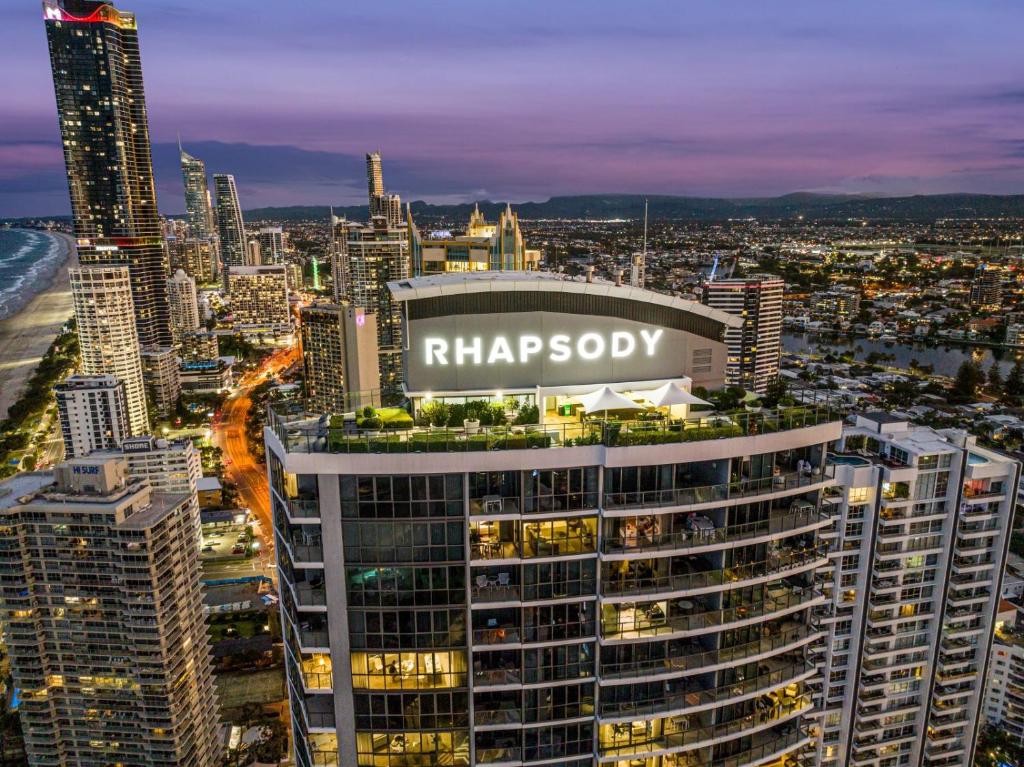 a view of a city skyline at night at Rhapsody Resort - Official in Gold Coast