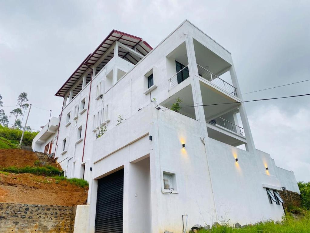 a white building on top of a hill at Kottagala White House in Kotagala
