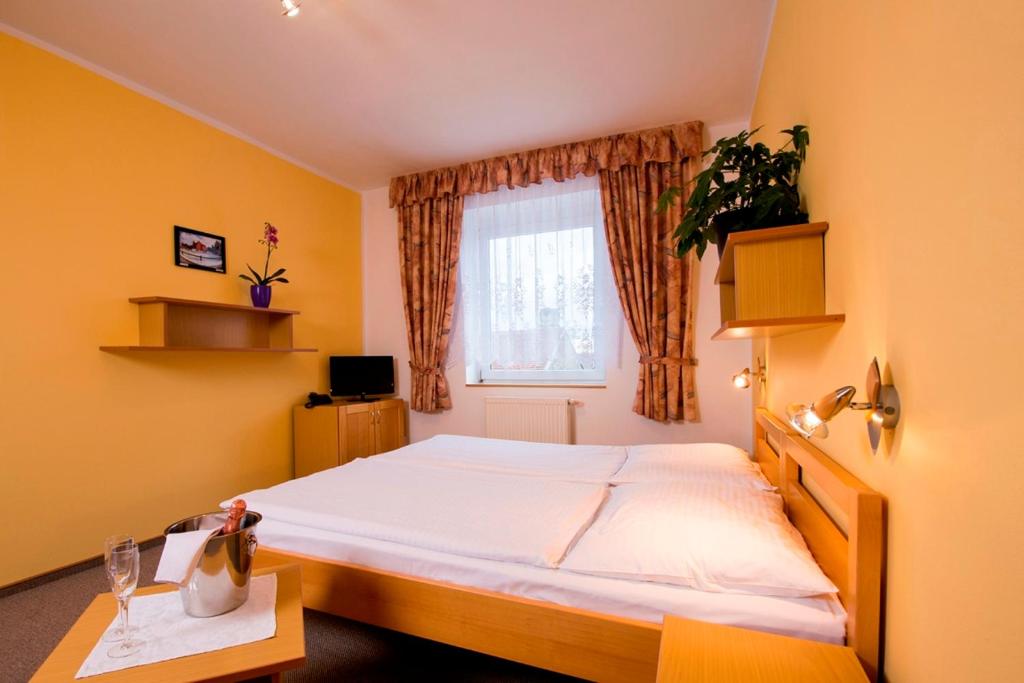 Postel nebo postele na pokoji v ubytování Penzion Bohemia