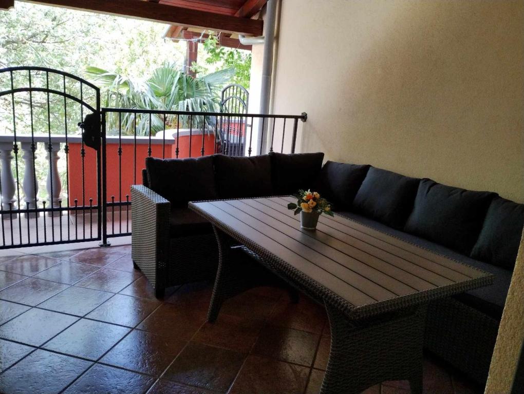 a living room with a couch and a wooden table at Apartment Keti in Čižići