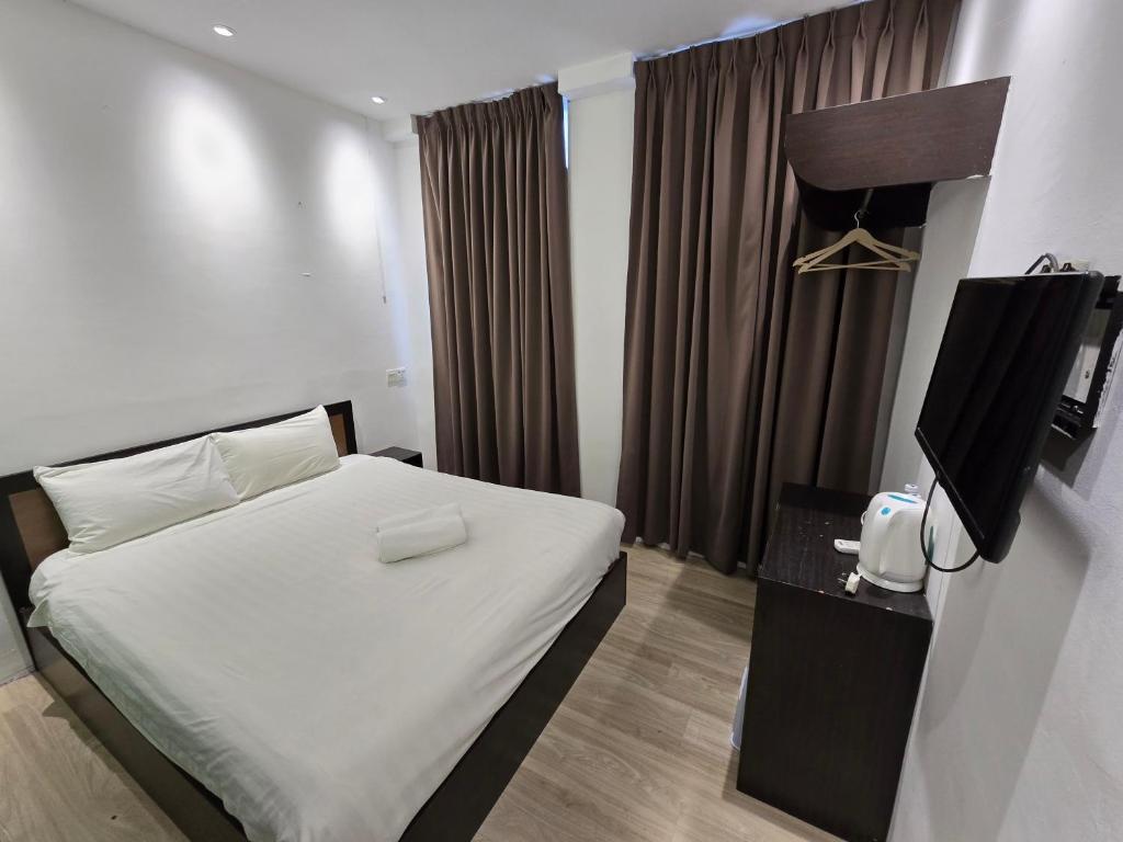 Postel nebo postele na pokoji v ubytování One Point Inn King Centre
