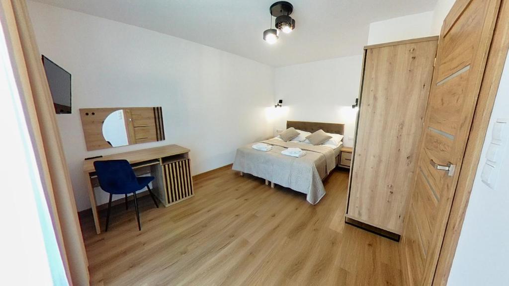Łóżko lub łóżka w pokoju w obiekcie Apartament ARKA