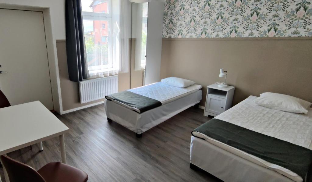 Postel nebo postele na pokoji v ubytování Lilla Hotellet i Nybro