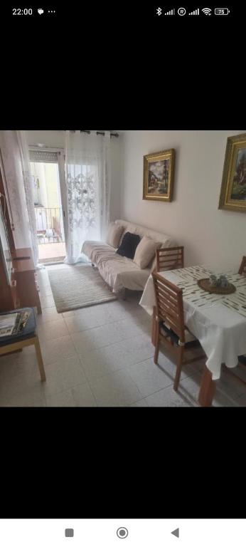 a living room with a couch and a table at Hogar calido calafell in Calafell