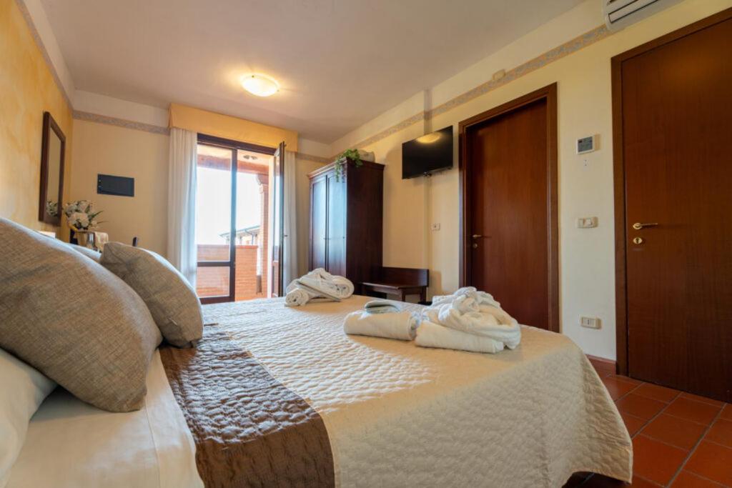 A bed or beds in a room at Hotel Borgo degli Olivi