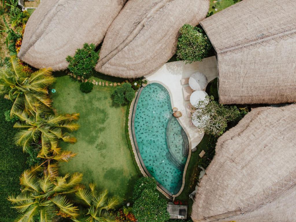 an overhead view of a swimming pool in a resort at Villa Omah Padi Ubud in Ubud