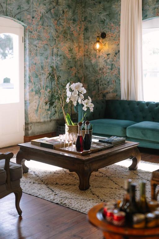 a living room with a couch and a coffee table at Auberge Burgundy Boutique Hotel & Spa in Hermanus