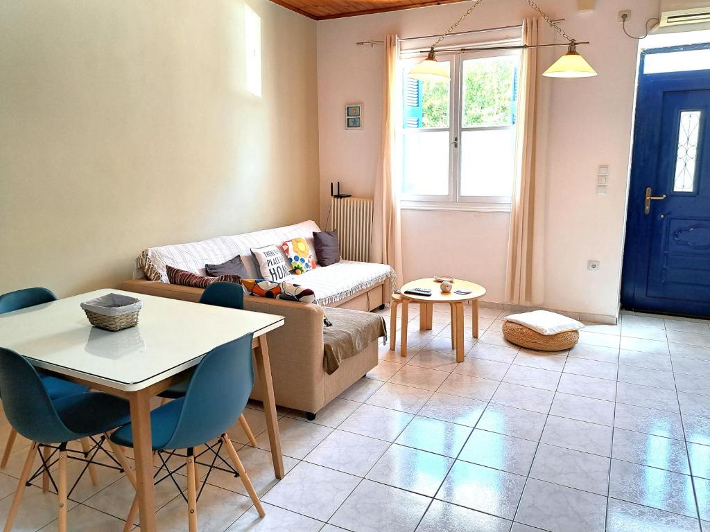 a living room with a couch and a table at Family stone apartment in Kyparissia