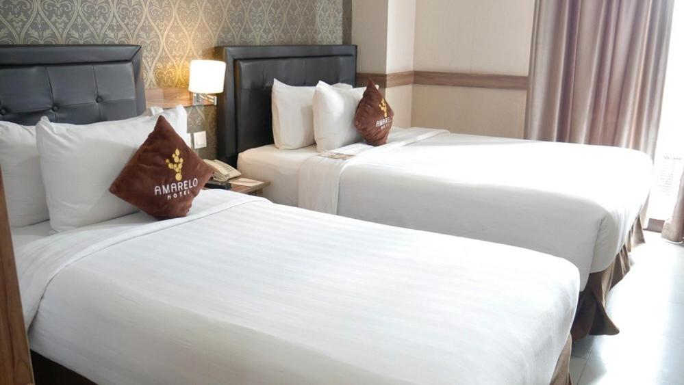 Ένα ή περισσότερα κρεβάτια σε δωμάτιο στο Amarelo Hotel Solo