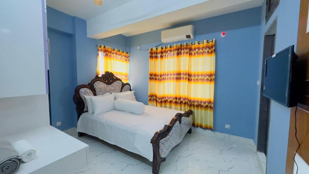 Ένα ή περισσότερα κρεβάτια σε δωμάτιο στο Baridhara Sweet Home