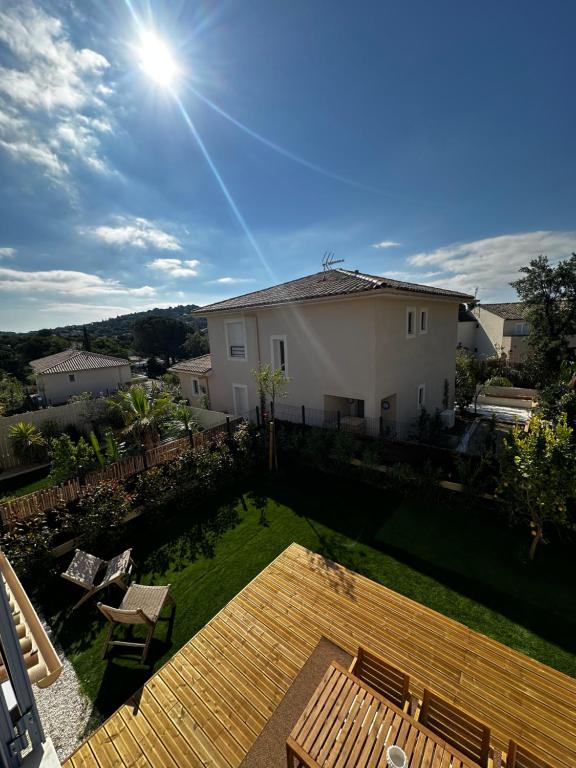 a view of a backyard with a wooden deck at Maison Golfe de Saint Tropez in Sainte-Maxime