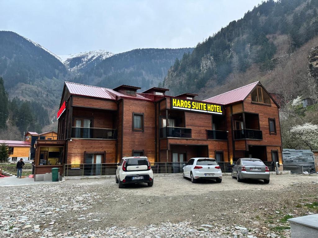 a large building with cars parked in front of it at Haros Suite Hotel in Uzungol