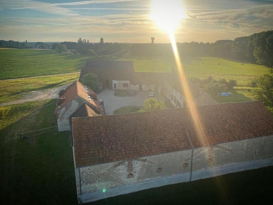 a view of a building with the sun shining on it at Villenouan domaine et gites in Lailly-en-Val