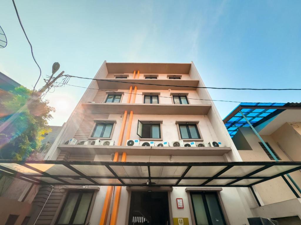 a tall building with a balcony in front of it at Beranda Plus near Hayam Wuruk 2 in Jakarta