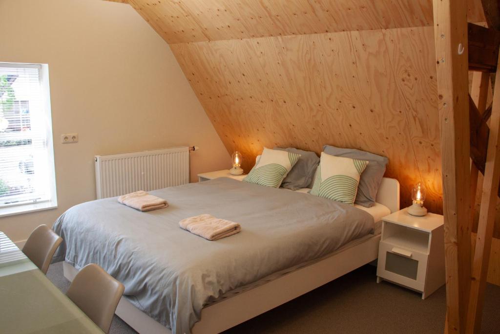 Ένα ή περισσότερα κρεβάτια σε δωμάτιο στο B&B Wasboerderij Beek Ubbergen