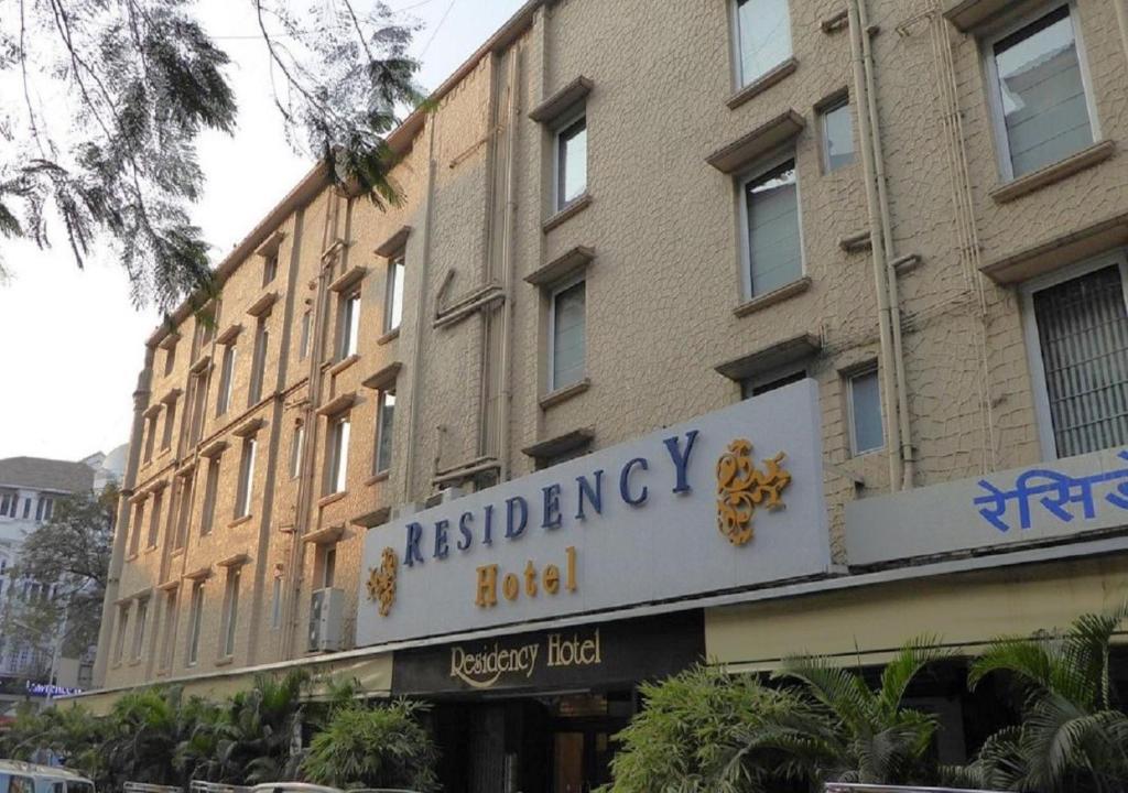 a brick building with a sign for a restaurant at Residency Hotel Fort in Mumbai