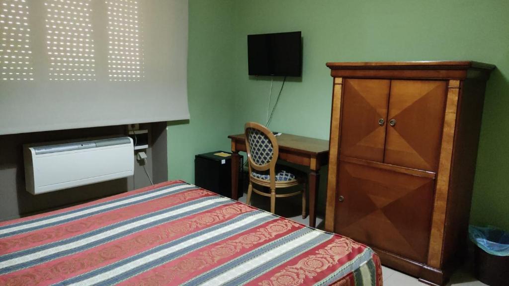 Postel nebo postele na pokoji v ubytování Hotel Plaza