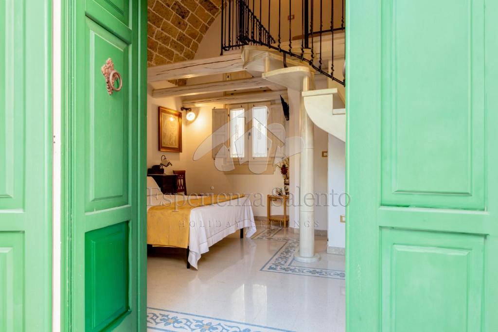a room with green doors and a bed in a room at SANTA LUCIA DIMORA in Taviano