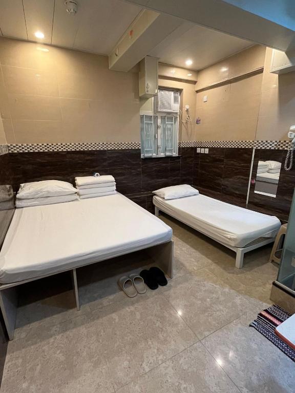 A bed or beds in a room at Kowloon Hostel