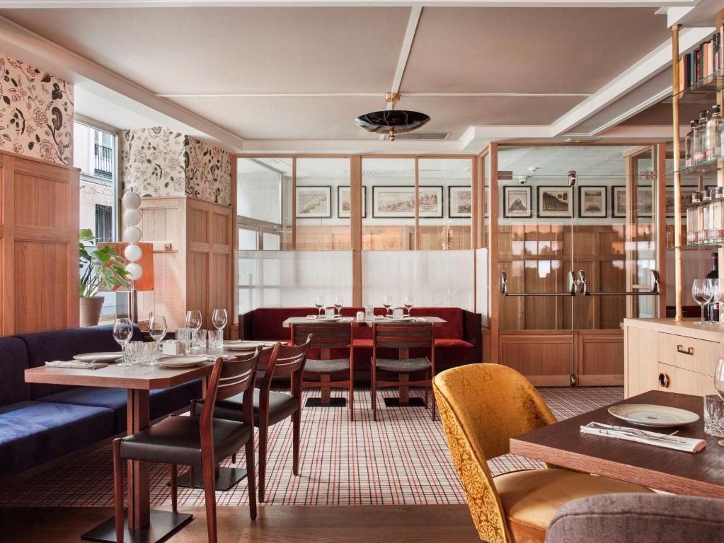 a dining room with a table and chairs at NH Collection Madrid Suecia in Madrid