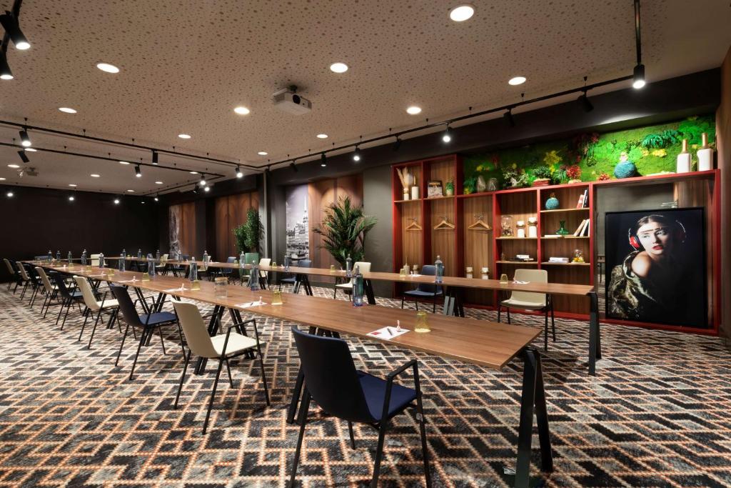 a long long table in a room with chairs at NH Collection Madrid Suecia in Madrid