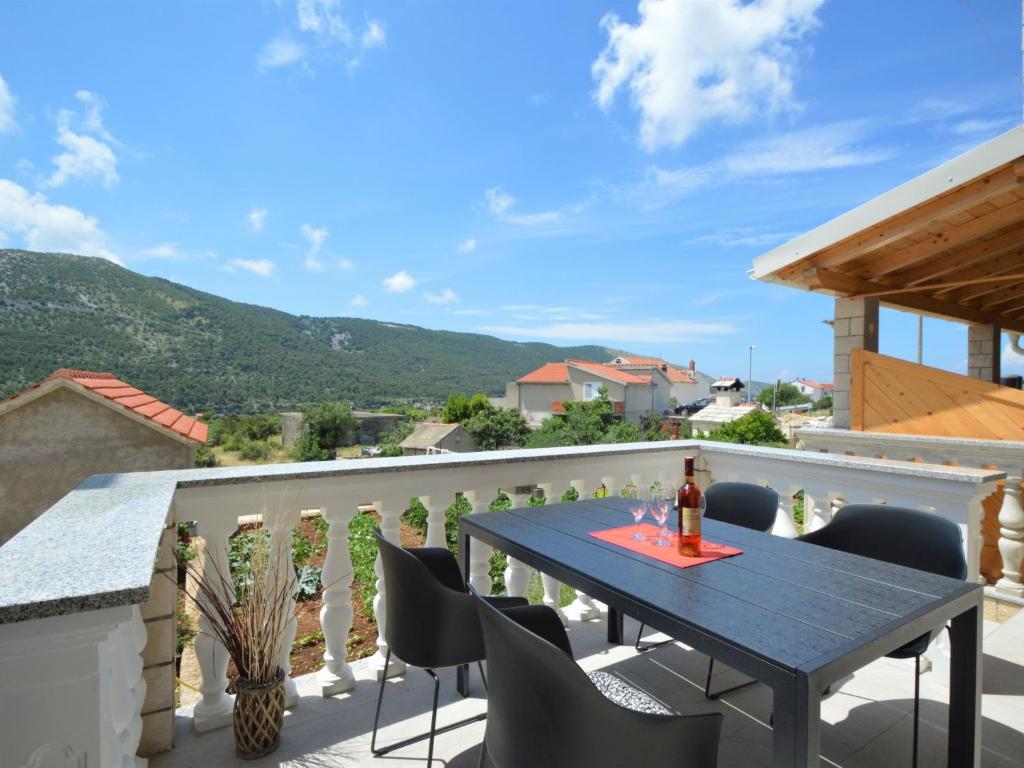 a patio with a table and chairs on a balcony at Apartment Miro-1 by Interhome in Grebaštica