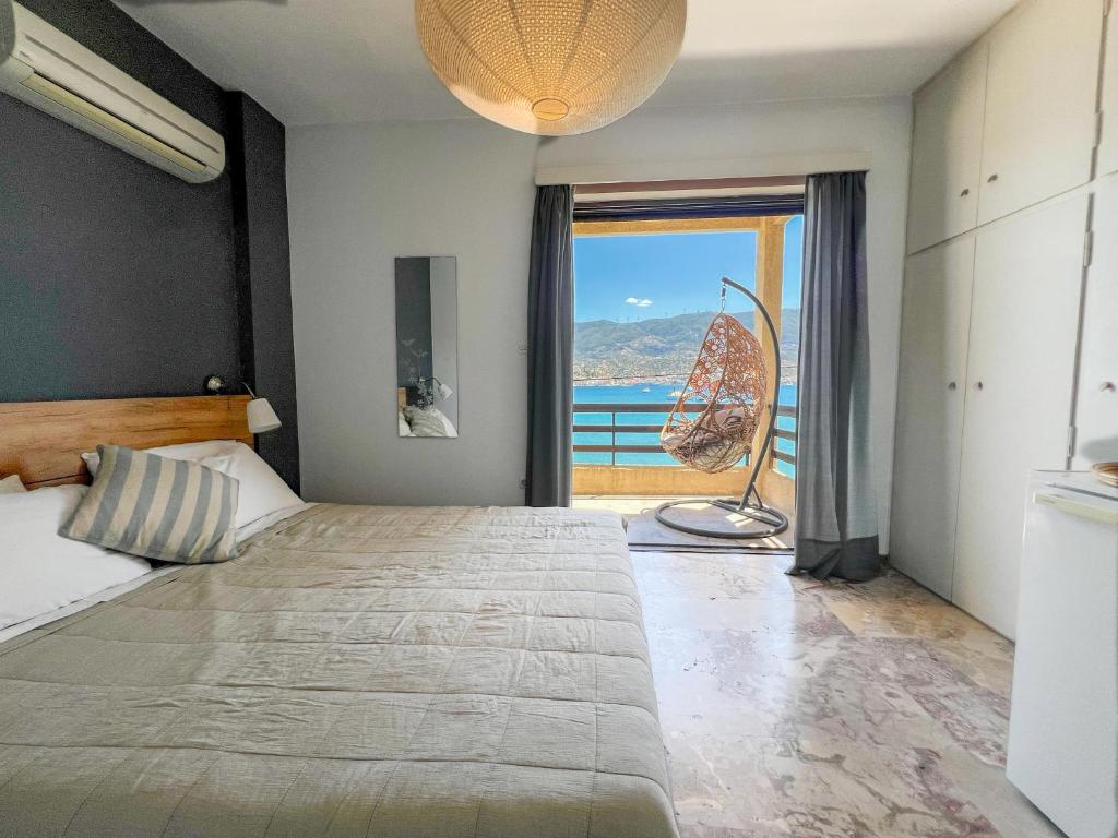 a bedroom with a bed with a view of the ocean at Villa Irene in Poros
