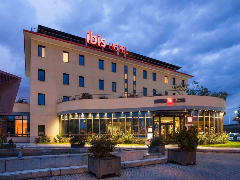 a hotel with a lit up sign on top of it at Ibis Valladolid in Valladolid