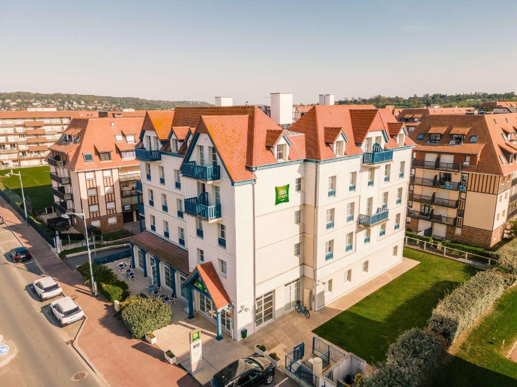 an overhead view of a large white building with orange roofs at ibis Styles Deauville Villers Plage in Villers-sur-Mer