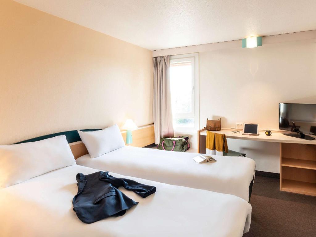 Postel nebo postele na pokoji v ubytování ibis Creil Sur Oise