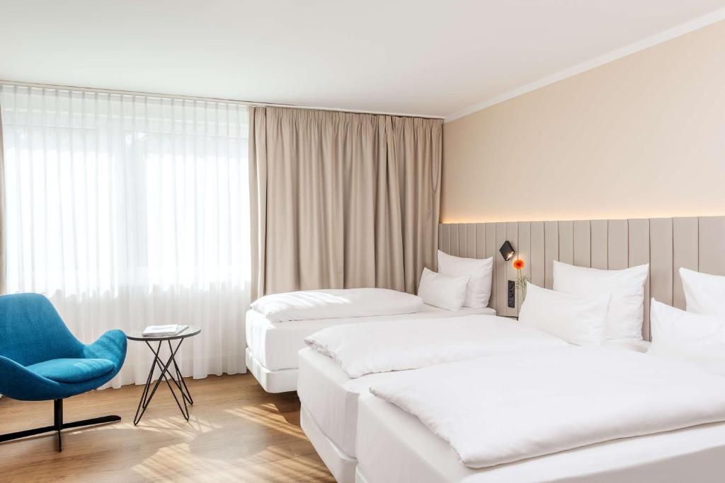 Postel nebo postele na pokoji v ubytování NH Köln Altstadt